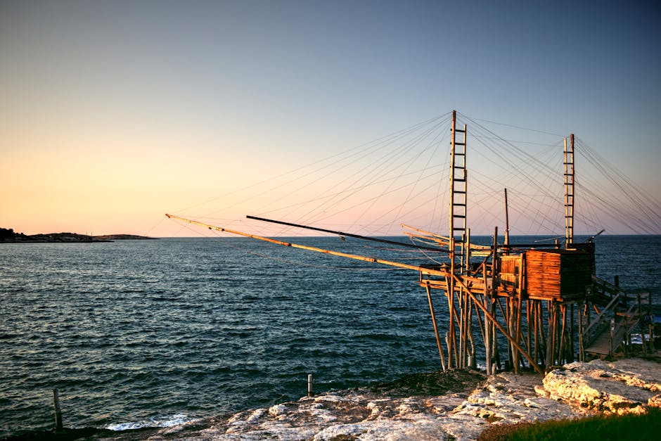 A stunning shot of Trabucco San Lorenzo in Vieste, Italy during sunrise over the Adriatic Sea.