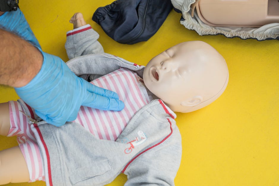 A person demonstrates infant CPR on a manikin, highlighting first aid techniques.