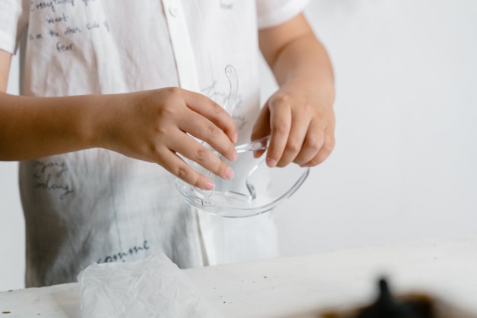 A child carefully holding safety glasses in a close-up photo, emphasizing safety. (Photo: MART PRODUCTION) A child carefully holding safety glasses in a close-up photo, emphasizing safety.