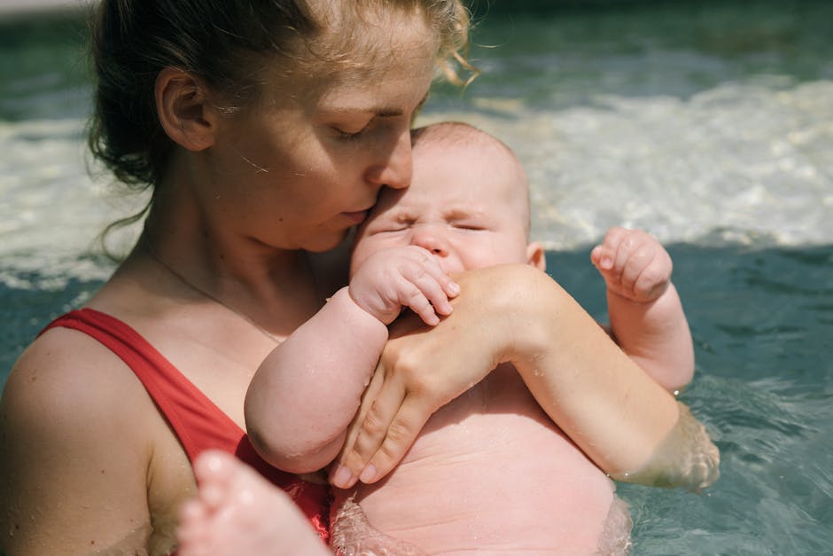 A tender moment of a mother holding her baby in a swimming pool, exemplifying love and care. (Photo: Yan Krukau) A tender moment of a mother holding her baby in a swimming pool, exemplifying love and care.