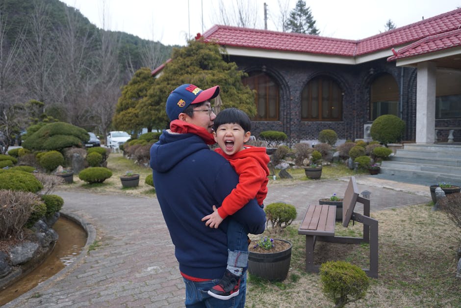 A happy father and son bonding in a lush Korean garden in Pyeongchang, South Korea.