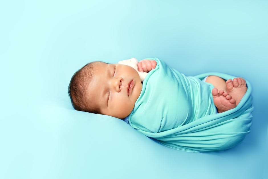 Peaceful newborn baby sleeping soundly in a cozy blanket.