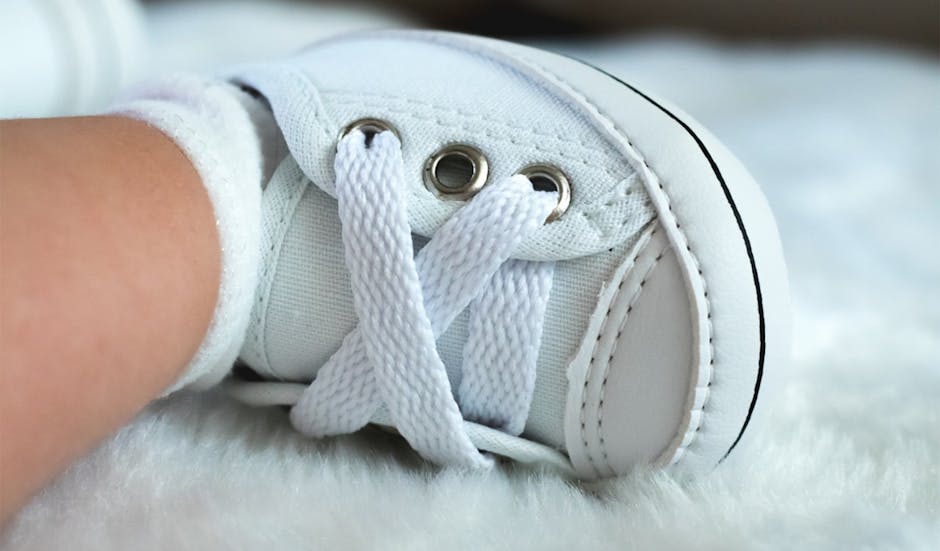 A detailed view of a white baby sneaker with laces, resting on a fluffy surface. (Photo: Jemima Brito) A detailed view of a white baby sneaker with laces, resting on a fluffy surface.