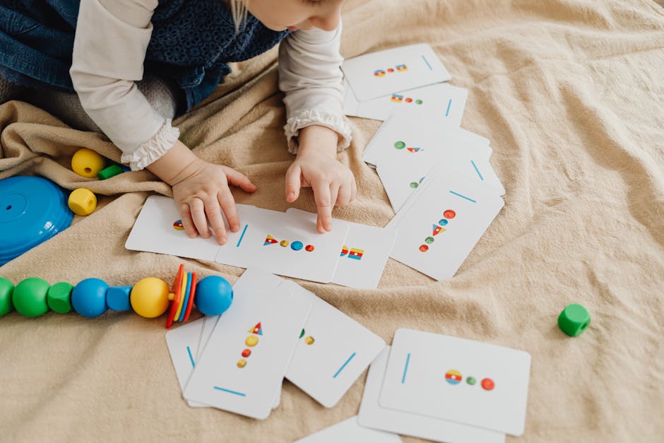 A child playing with educational cards and colorful toys, promoting cognitive skills and creativity. (Photo: www.kaboompics.com) A child playing with educational cards and colorful toys, promoting cognitive skills and creativity.