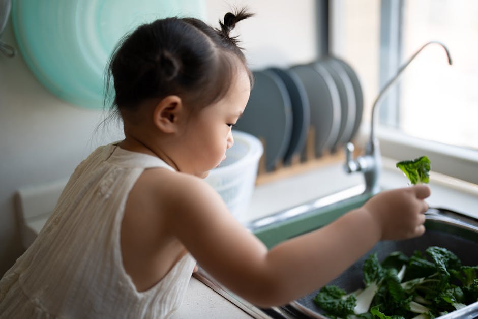 A child washing fresh vegetables at the sink, demonstrating healthy habits. (Photo: kenan zhang) A child washing fresh vegetables at the sink, demonstrating healthy habits.